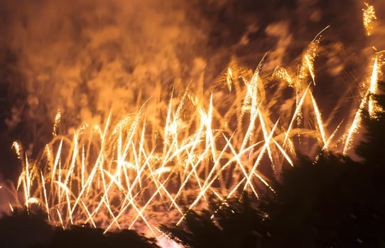 Colorful fireworks over dark sky, displayed during a celebration of Santa