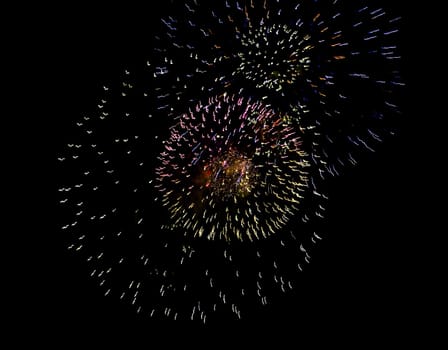 Colorful fireworks over dark sky, displayed during a celebration of Santa