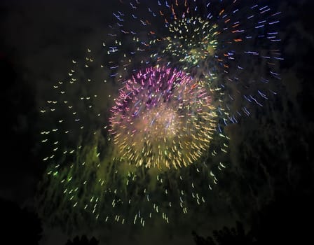 Colorful fireworks over dark sky, displayed during a celebration of Santa