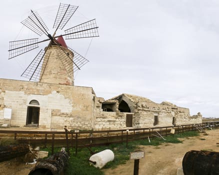 old windmill in sicily, trapani, italy