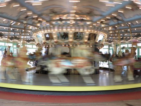 Antique carousel with carved horses at Glen Echo National Park in Maryland with motion blur