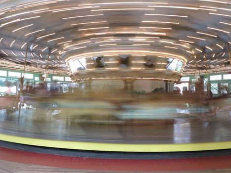 Antique carousel with carved horses at Glen Echo National Park in Maryland with motion blur