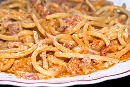 Pasta -Spaghetti and tomato sauce whit bacon and cream,close up