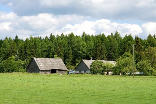 The house and field on a background of the  sky