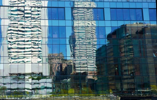 Uneven windows distort city skyline reflections