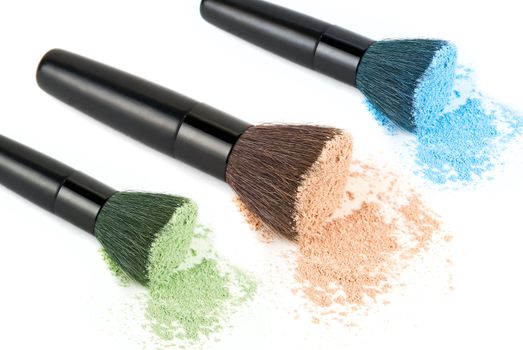 Color powders set with make-up brush on white