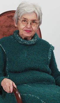 Portrait of an old woman against a grey background