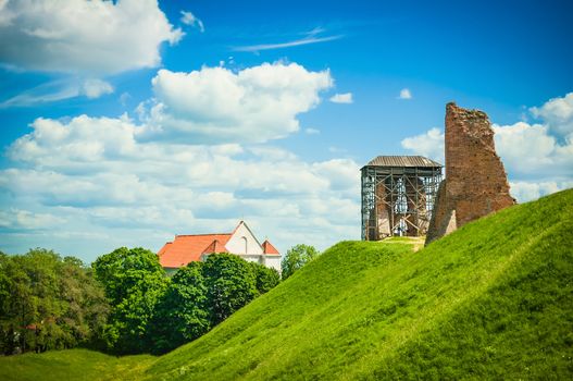 Castle ruins during renovation summer landscape