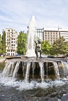 Fountain in Plaza d'Espana with Skyscrapers and trees in the background. Madrid- Spain