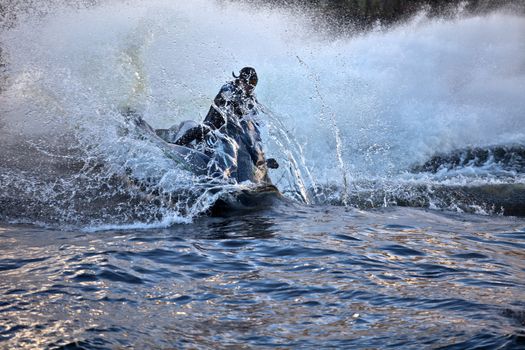 jet ski at high speed lifts a large wave