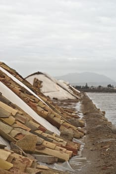 A salt mound for salt production with roof tiles in the Trapani,Sicily, Italy