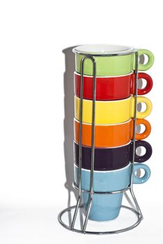 Stack of colorful empty coffee cups on steel support