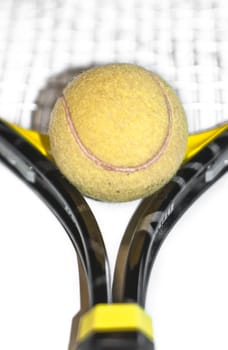 Tennis ball and racket isolated on white background