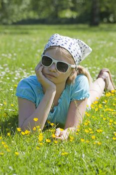 little girl lying on grass 