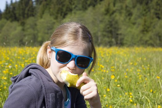 Young girl with fresh yellow pear
