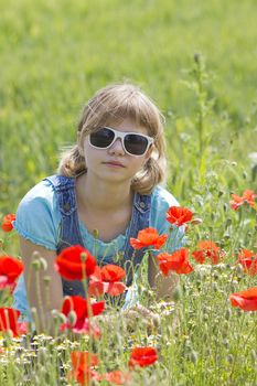 Cute young girl in poppy field