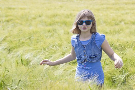 young girl in the field of barley 