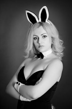 Monochrome portrait of a girl - rabbit on dark background