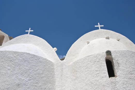 The Twin Domes of a medieval Greek Chapel in Santorini Greece