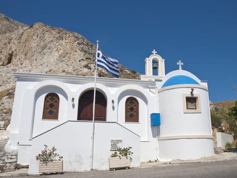 A Small Greek Orthodox Church and Bell Tower with Greek Flag Flying