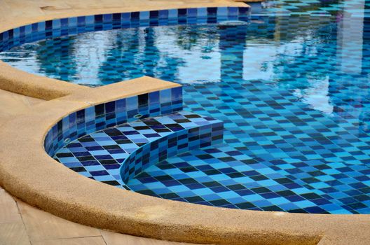 Swimming pool with step and seat