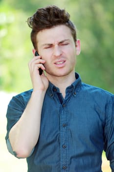 Disappointed young red hair man at telephone