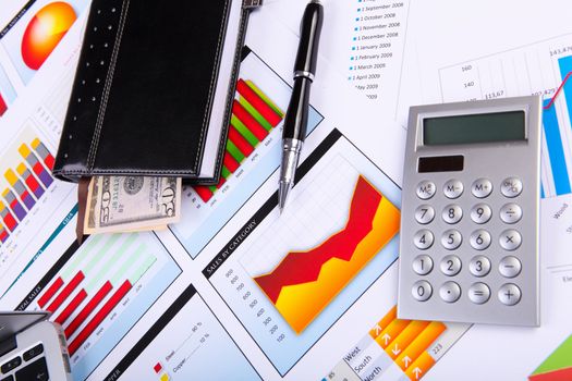 Financial paper charts and graphs on the table