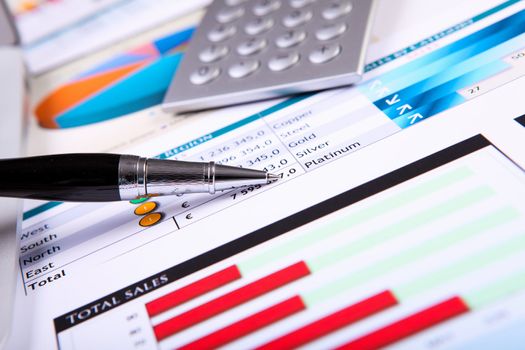 Financial paper charts and graphs on the table