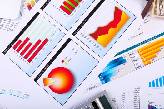 Financial paper charts and graphs on the table