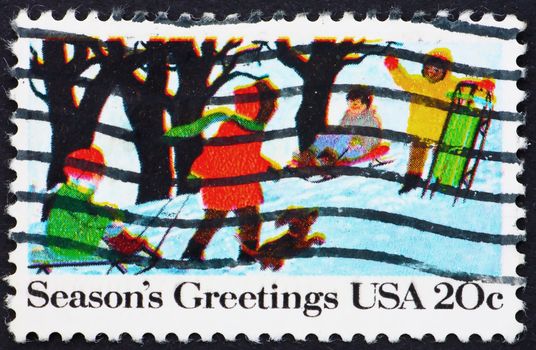 UNITED STATES OF AMERICA - CIRCA 1982: a stamp printed in the USA shows Children Playing in the Snow, Christmas, circa 1982