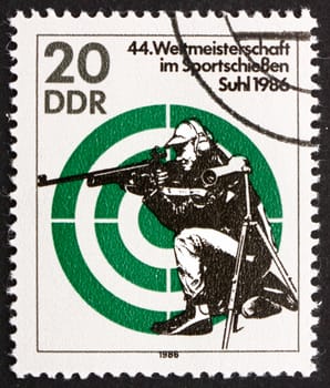GDR - CIRCA 1986: a stamp printed in GDR shows Rifle Shooting, 44th World Sports Shooting Championships, Suhl, circa 1986