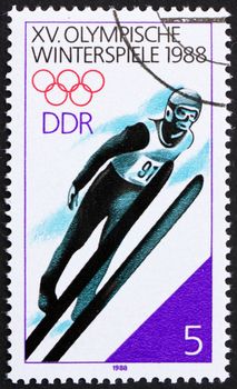 GDR - CIRCA 1988: a stamp printed in GDR shows Ski Jumping, 15th Winter Olympics, Calgary, Canada, circa 1988