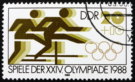 GDR - CIRCA 1988: a stamp printed in GDR shows Hurdle Race, 24th Summer Olympics, Seoul, South Korea, circa 1988