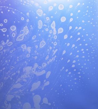 abstract wet blue background with soap bubble conglomerations