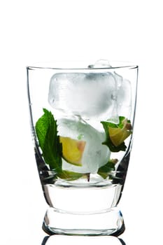 Closeup of glass with limes mint and ice cube on White background