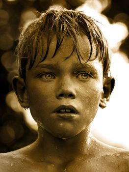 Vintage portrait of a child with water drop on face