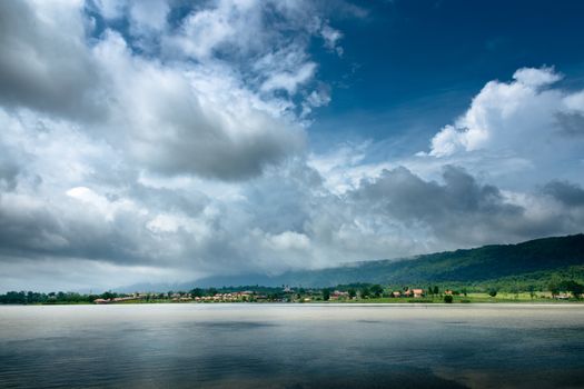 Dark Cloud on blue sky and green Mountain