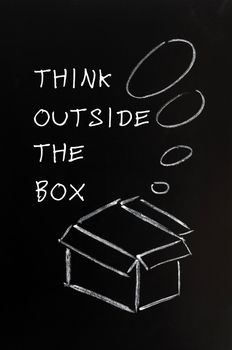 Concept of "Think outside the box" drawn with chalk on a blackboard 