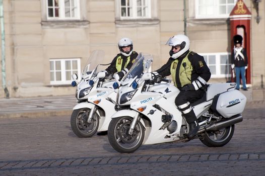 Motorized policemen patrol the area of a royal palace in Copenhagen, Denmark