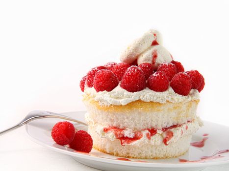Raspberry and whip cream cupcakes on white background