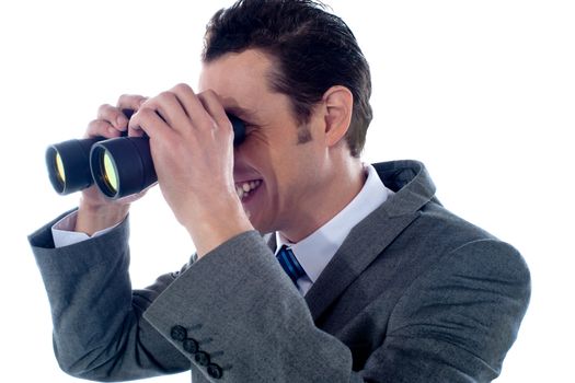 Male executive using binoculars isolated on white background