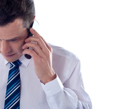 Cropped image of man talking on cell phone and looking down