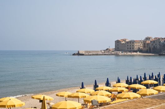 beach of Cefalù, with yellow umbrellas