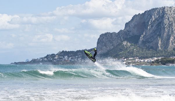 man jumps on the jet ski above the water at Mondello. Sicily