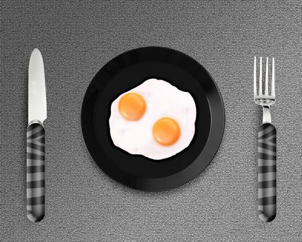top view of two fried eggs on black Plate between silver knife and fork on gray background.