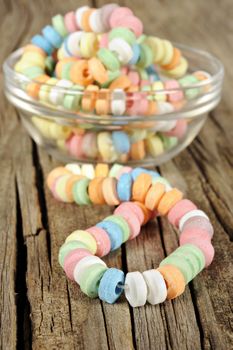 Candy on strings on wooden background