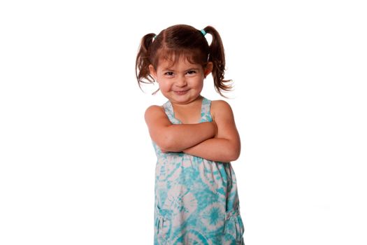 Cute little young toddler girl with attitude smirk, arms crossed and pigtails in hair, naughty rascal expression, isolated.