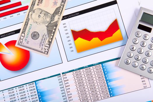 Financial paper charts and graphs on the table