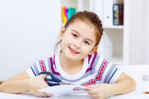 Little girl sitting and studying at home