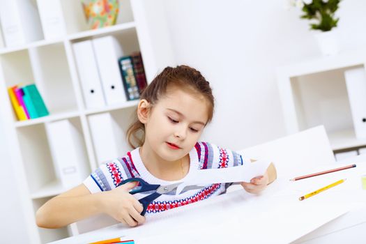 Little girl sitting and studying at home